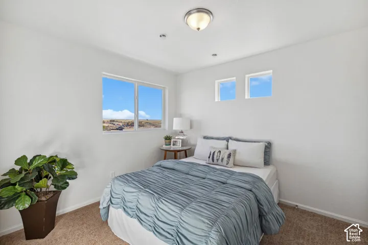 Two distinct windows, recessed lighting, and a flush-mount ceiling fixture illuminate this space