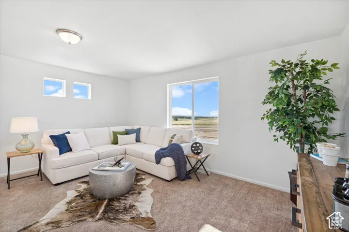 Spacious interior with neutral carpeting and white wall finishes