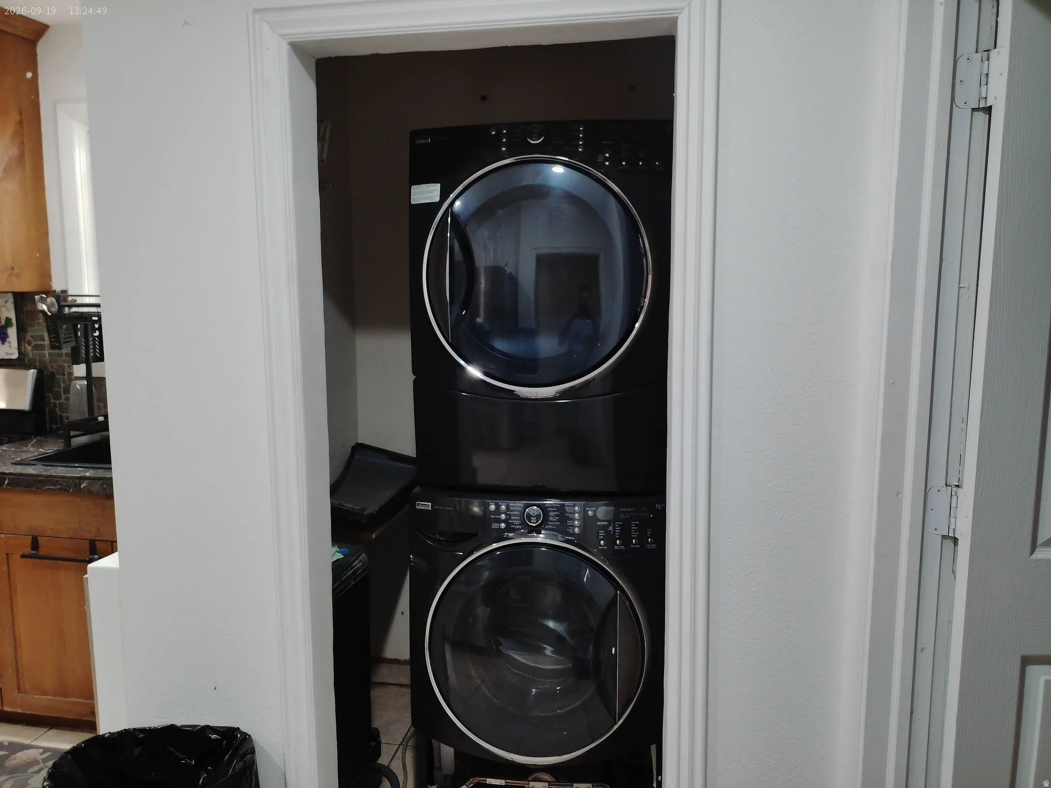 Stackable laundry appliances within a dedicated utility space