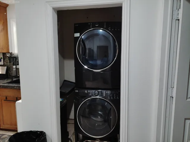 Stackable laundry appliances within a dedicated utility space