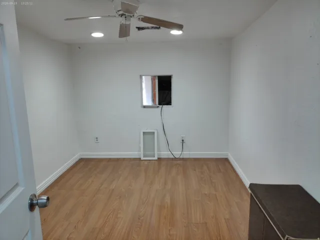 Wood-finish flooring, recessed lighting, and a ceiling fan with integrated lighting