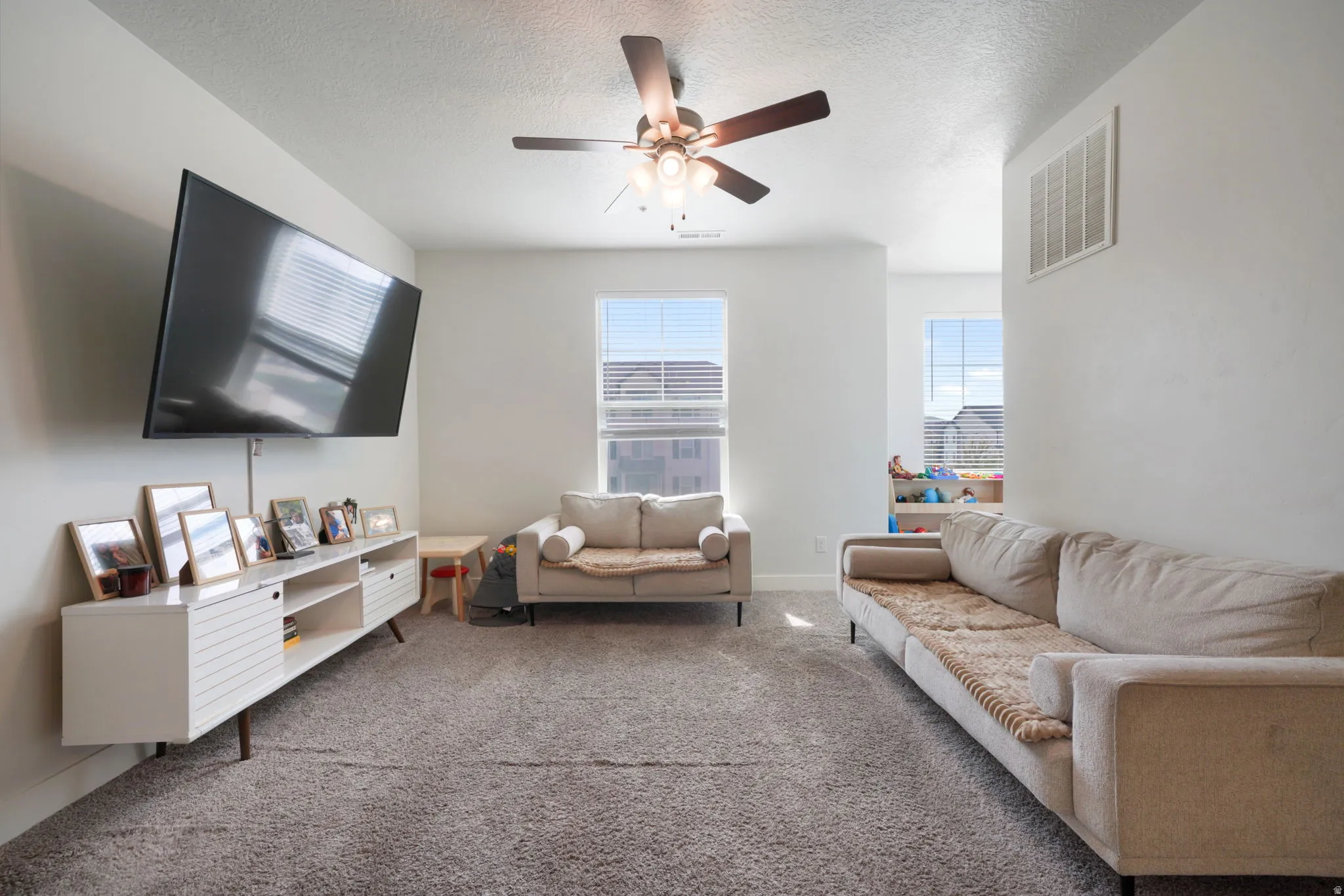 Recessed lighting, ceiling fan, and carpeted flooring