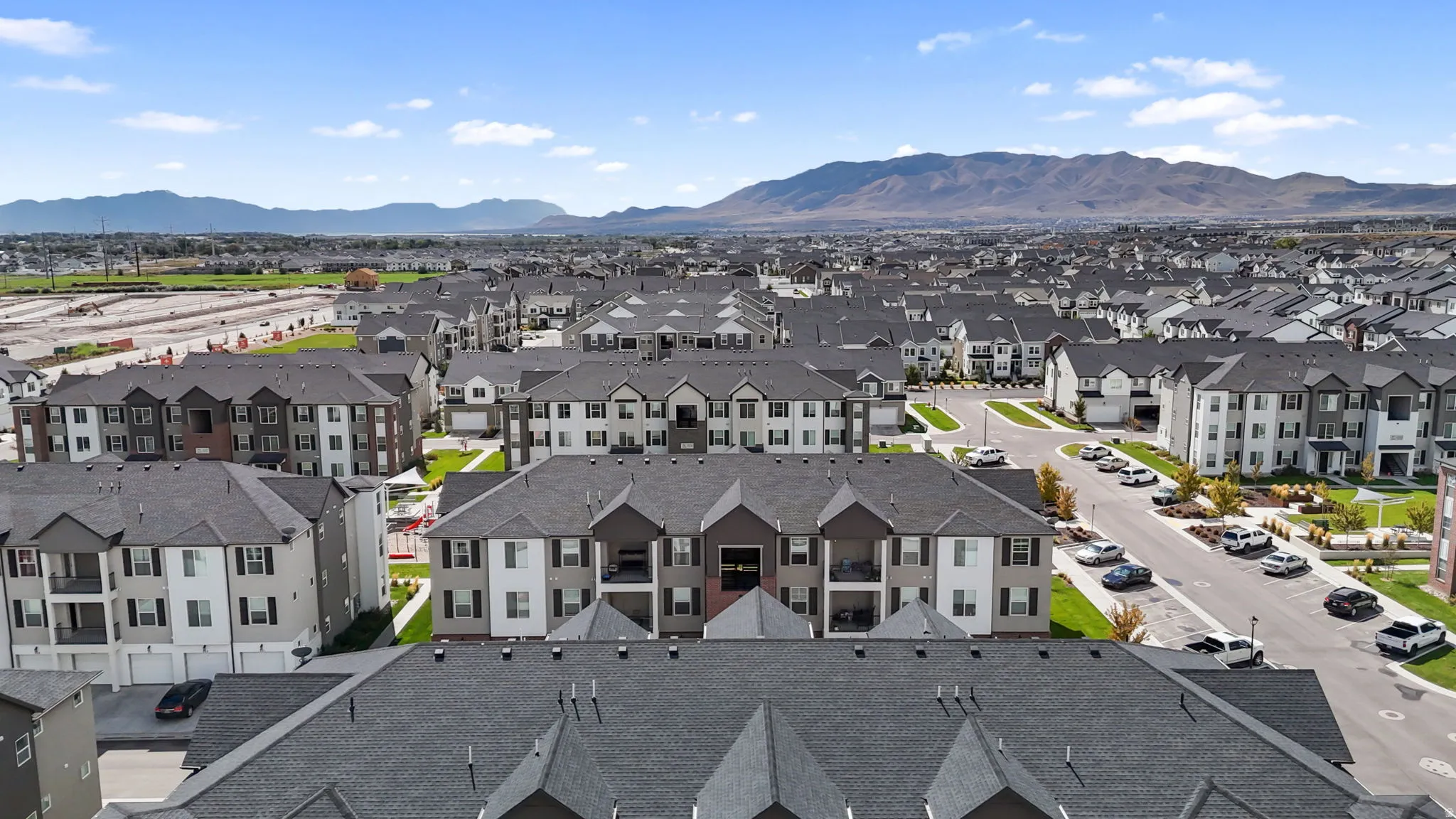 Residential development featuring multi-story buildings with dark shingle roofs