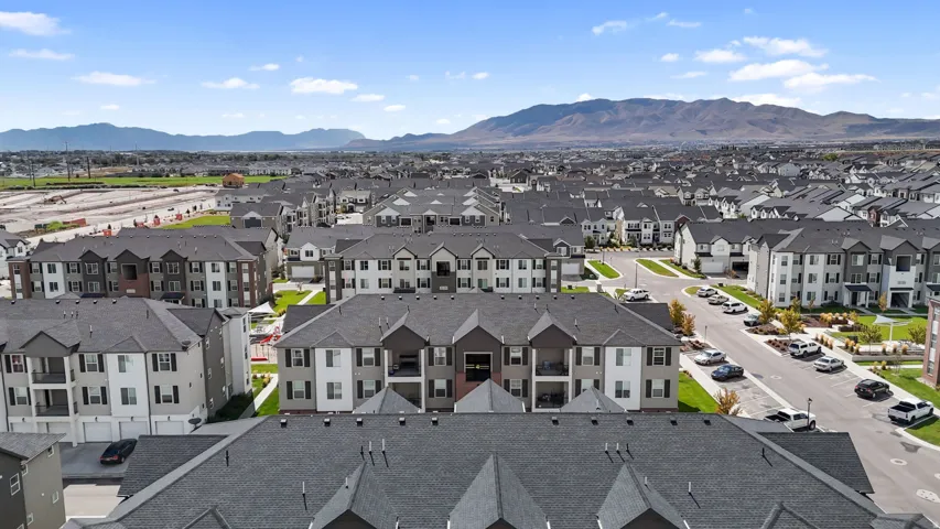 Residential development featuring multi-story buildings with dark shingle roofs