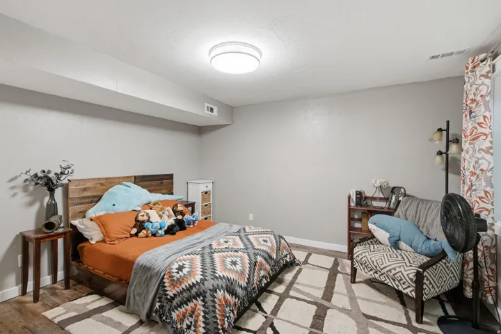Recessed ceiling beam with flush-mount lighting, wood-finish flooring, and light gray wall paint
