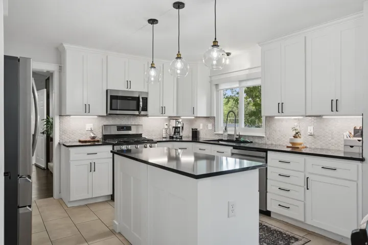 White shaker-style cabinetry with matte black hardware