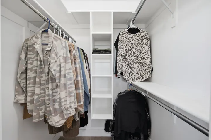 Built-in closet system with shelving and hanging rods