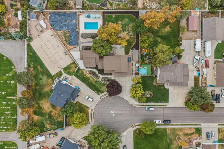 Expansive lot featuring a sports court, inground swimming pool, and mature landscaping