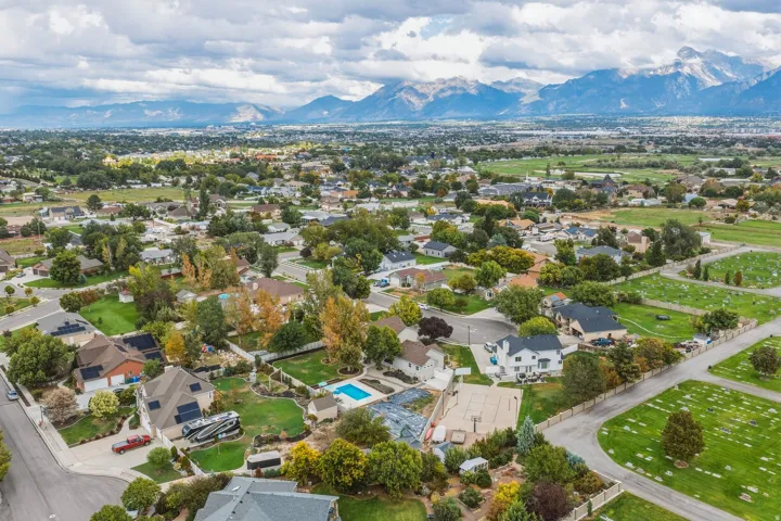 Expansive residential area with mature trees, surrounded by distant mountains