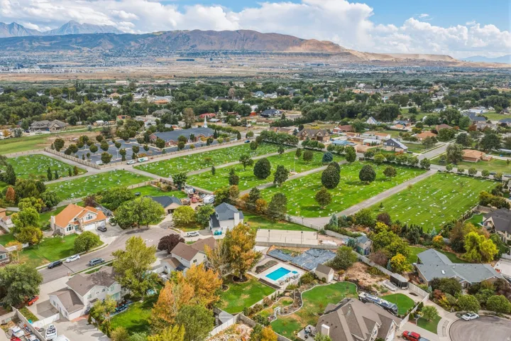 Expansive neighborhood setting with established homes, mature trees, and mountainous terrain