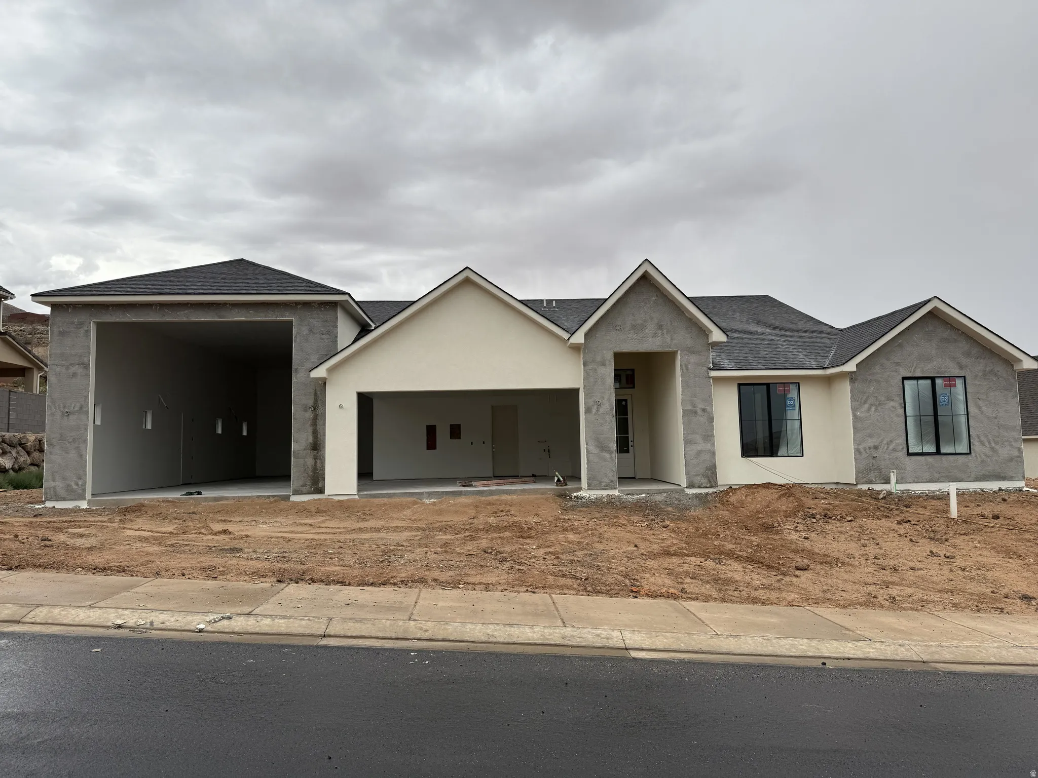 Contemporary architectural design featuring a multi-gabled roofline and a combination of stucco finishes