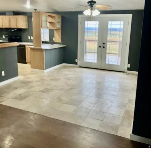 Kitchen with wood-finish cabinetry, built-in breakfast bar, and tile flooring