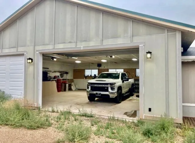 Two-bay garage with overhead lighting and exterior wall sconces