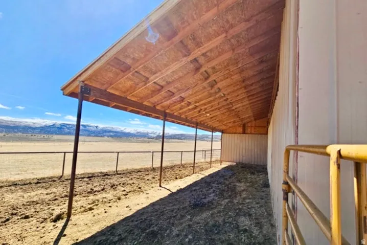 Expansive covered outdoor structure with a pitched wood-finish ceiling and metal support beams