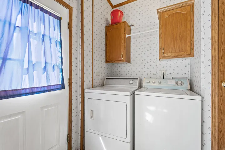 Laundry area with built-in cabinetry and dedicated appliance space
