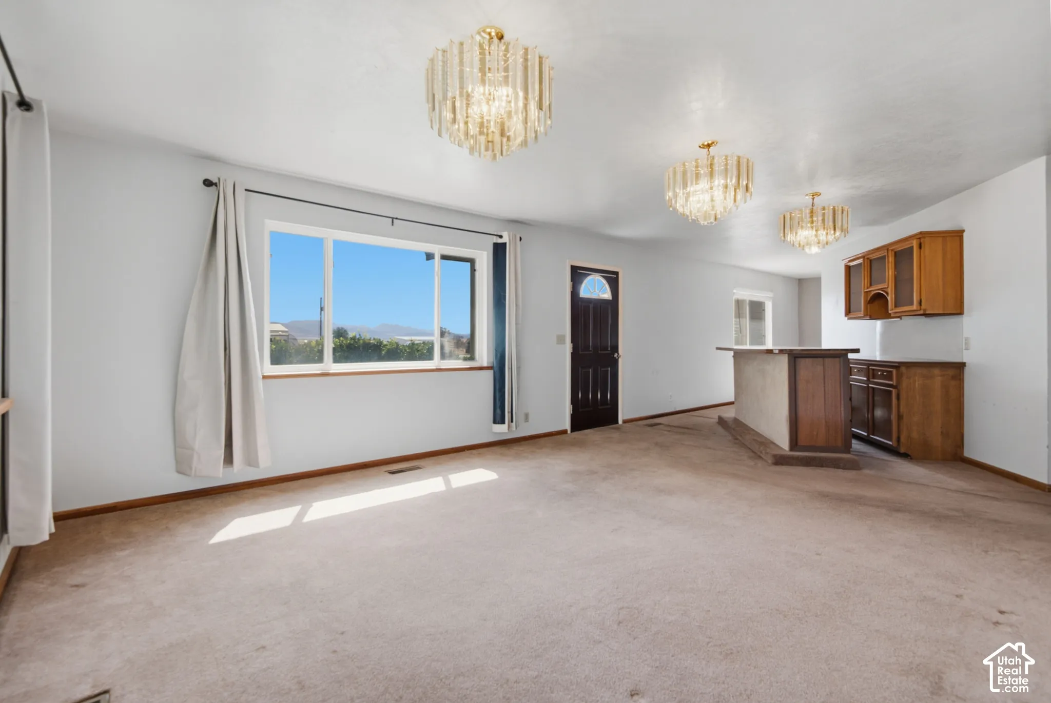 Spacious interior with neutral carpeting and light-colored walls