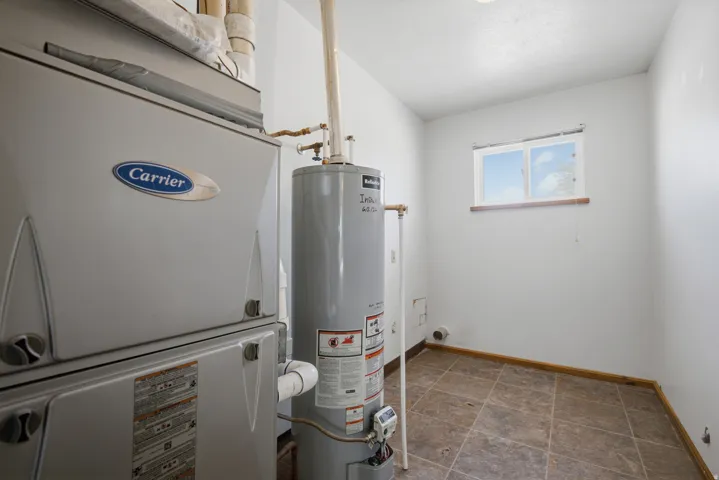 Carrier HVAC system, water heater, tiled flooring, and a single window