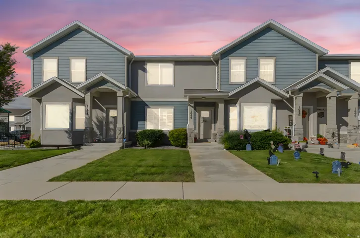 Two-story townhouse with blue siding and gray stucco accents