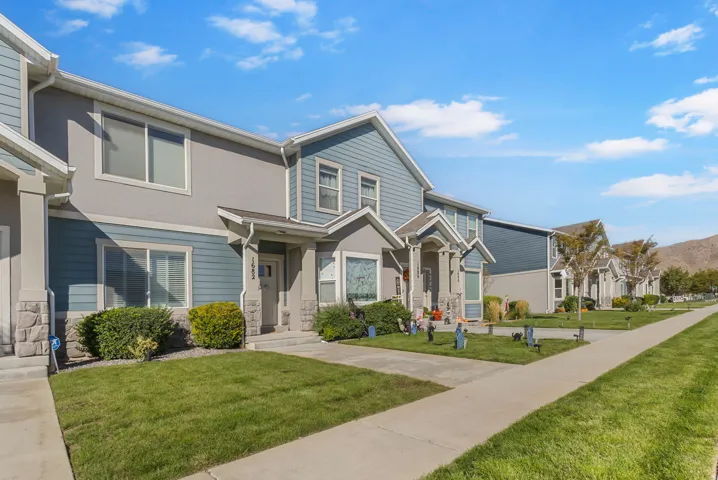 Two-story exterior with blue siding and stone veneer accents
