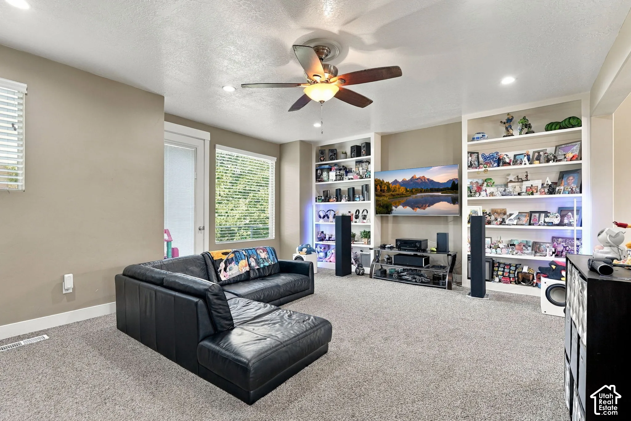 Recessed lighting, ceiling fan, built-in shelving, carpet flooring, and window blinds