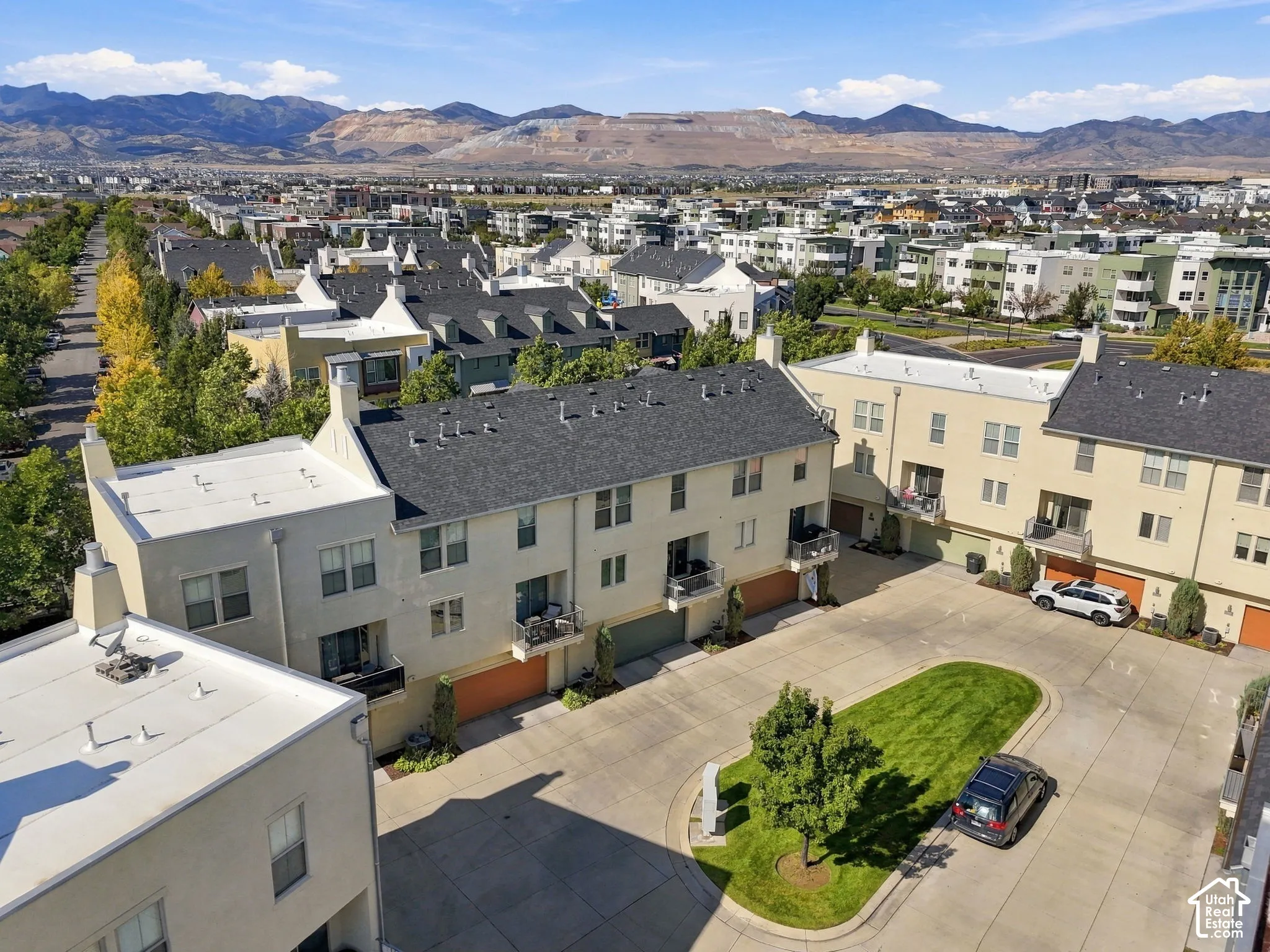 Townhome community featuring neutral stucco exteriors, attached garages, and private balconies