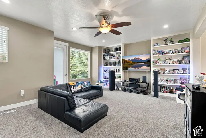 Recessed lighting, ceiling fan, built-in shelving, carpet flooring, and window blinds