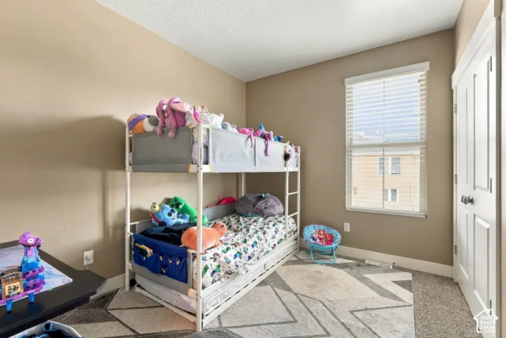 Neutral-toned wall paint, window with blinds, white trim, and a matching white door