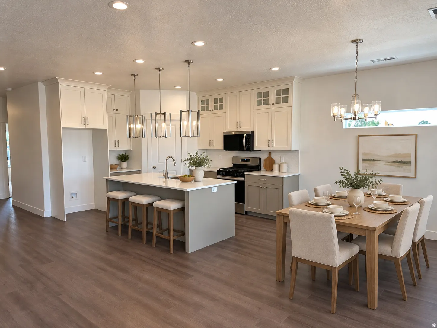 Spacious kitchen with a central island, white cabinetry, integrated range, wood-finish flooring, and recessed lighting
