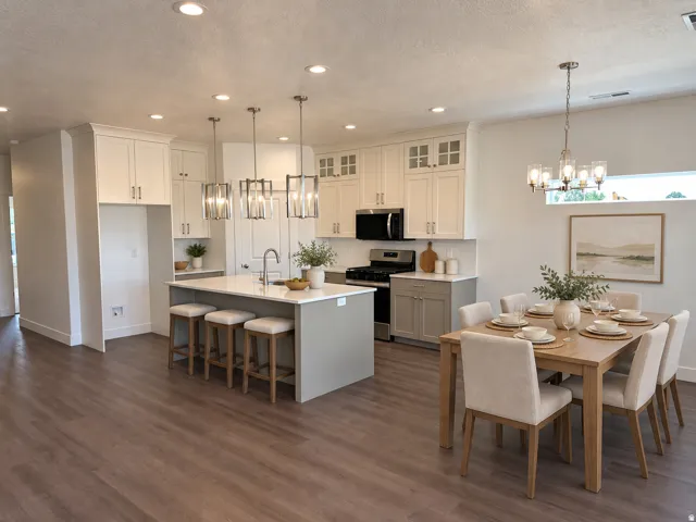 Spacious kitchen with a central island, white cabinetry, integrated range, wood-finish flooring, and recessed lighting