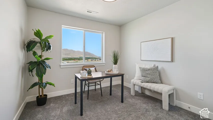 Wall-to-wall carpeting, neutral wall finishes, and a large window providing expansive scenery