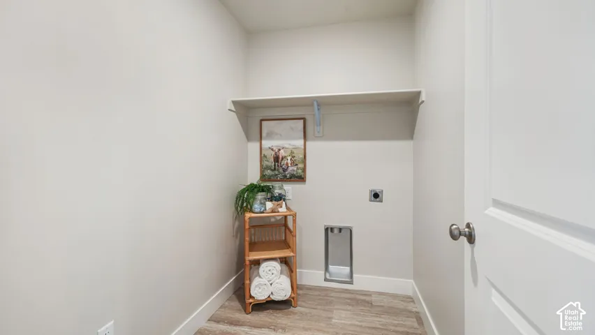 Integrated laundry hookups, built-in shelving, durable wood-finish flooring, and crisp white trim