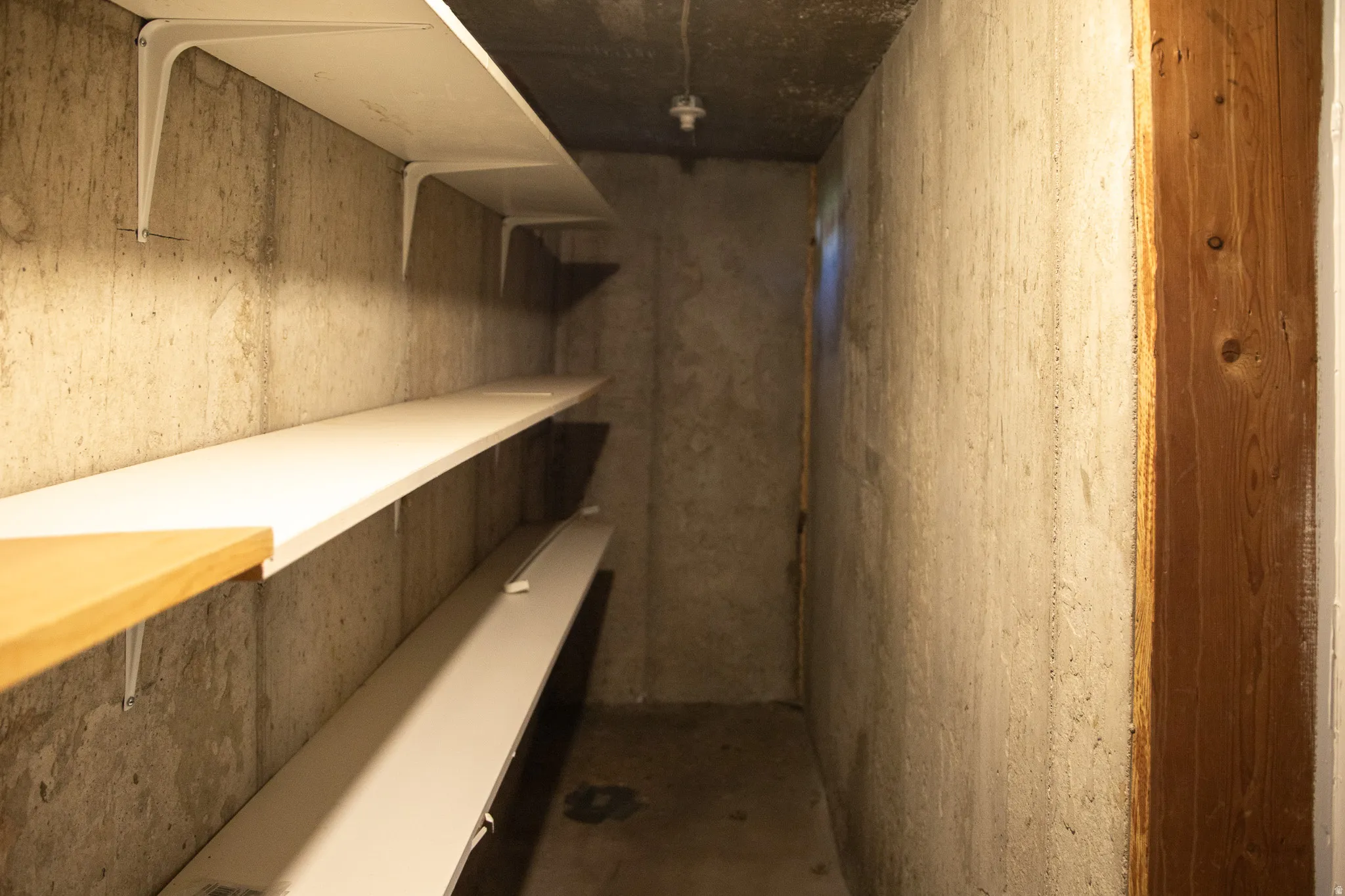 Concrete walls featuring built-in shelving