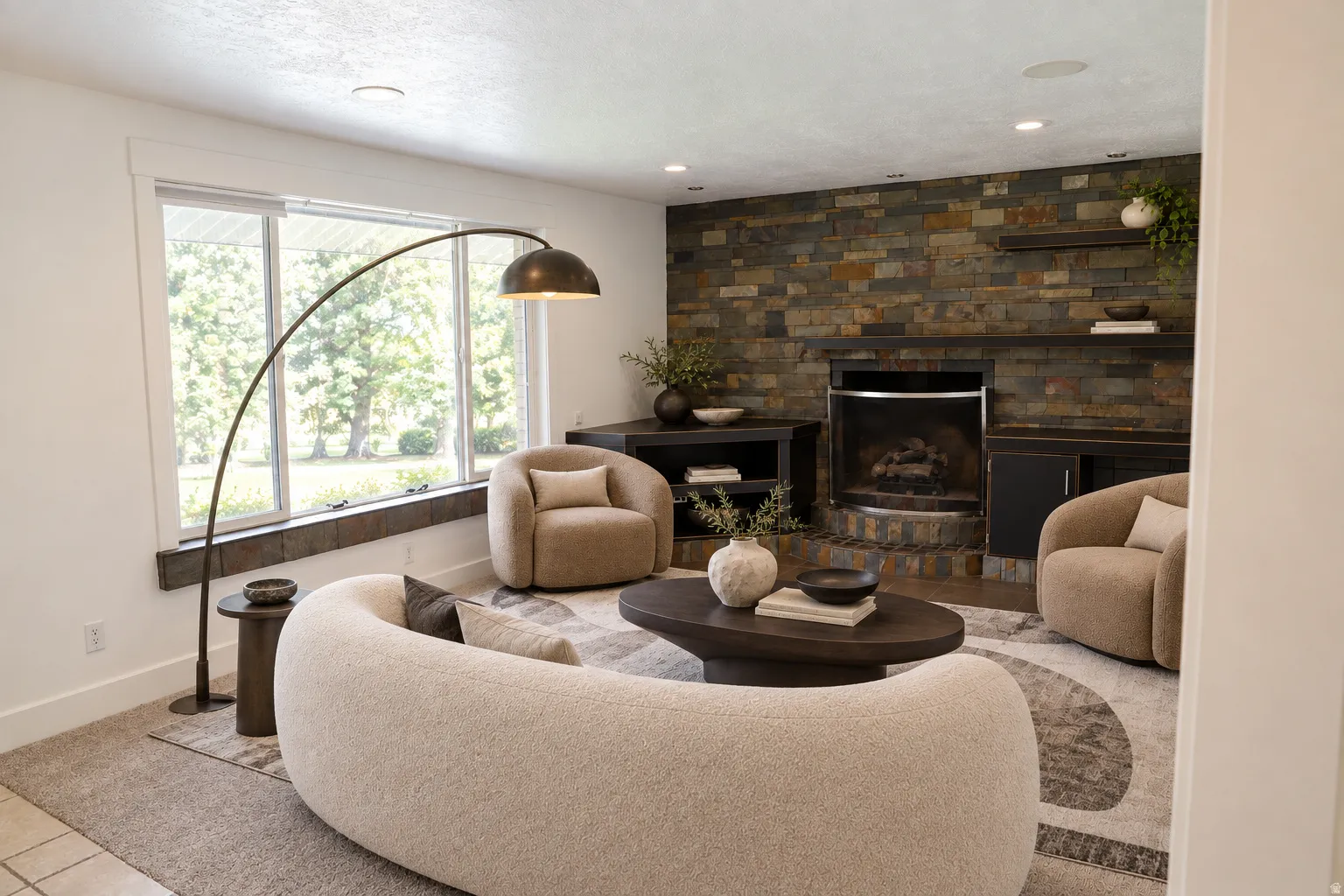 Stone accent wall with fireplace, built-in shelving, and recessed lighting