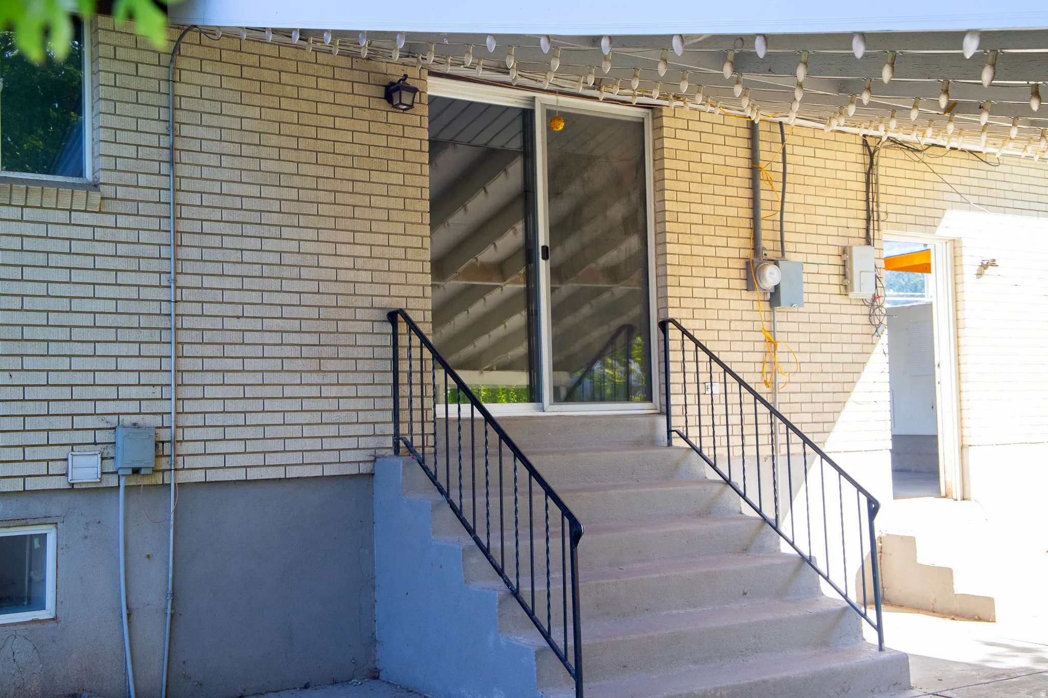 Brick exterior with a sliding glass door entry