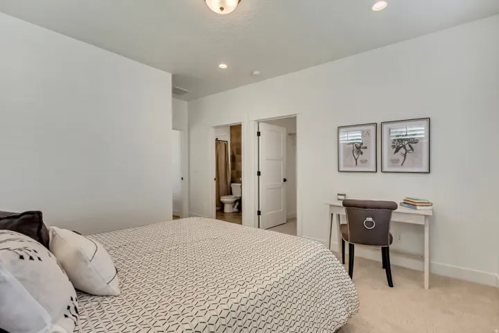 Recessed lighting, light-toned carpeting, and a three-panel interior door