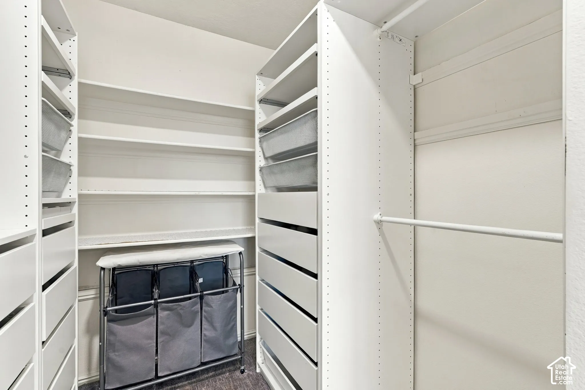 Custom closet system featuring extensive shelving, multiple drawers, and a hanging rod