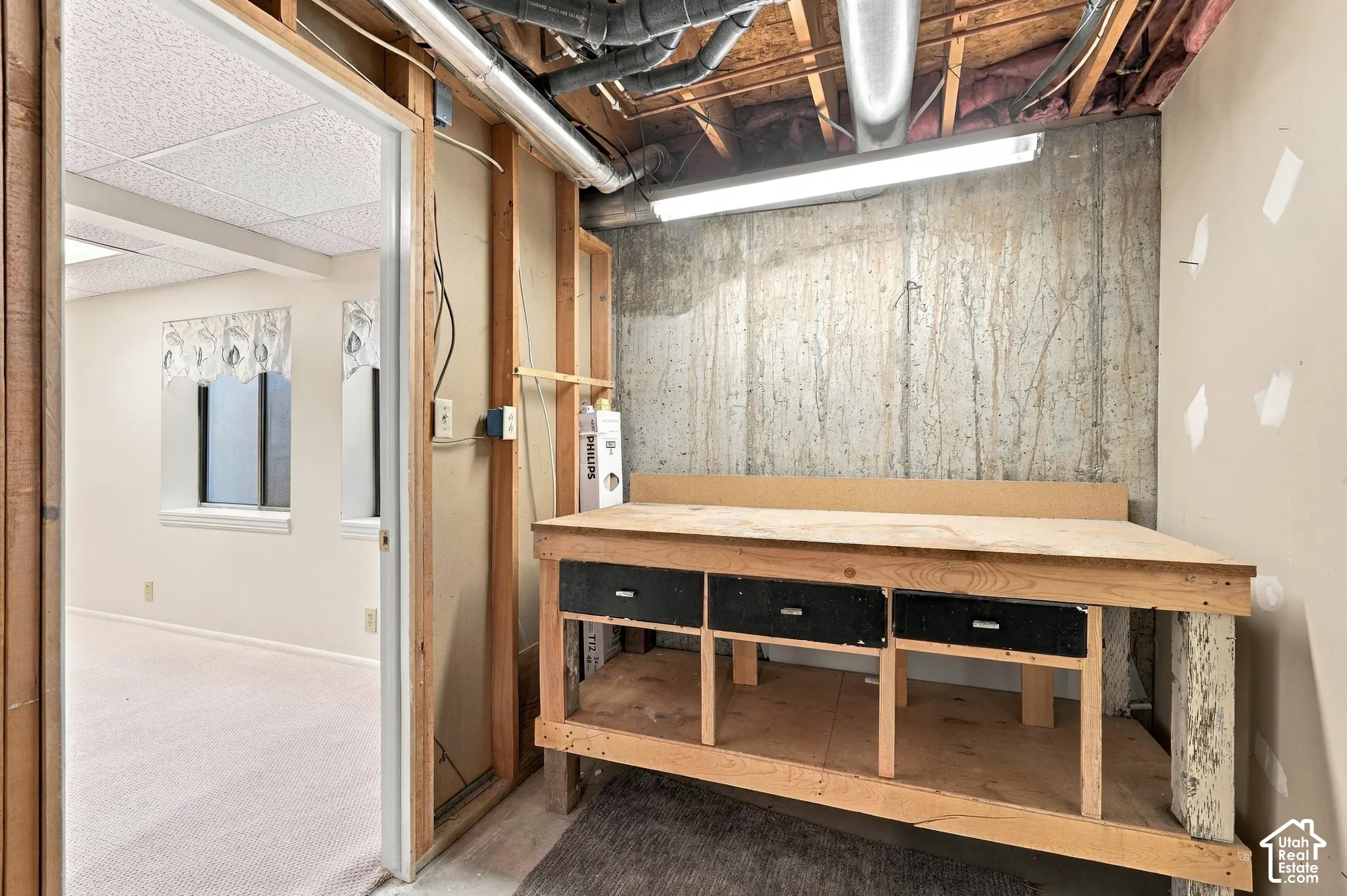 Concrete wall with exposed ceiling joists