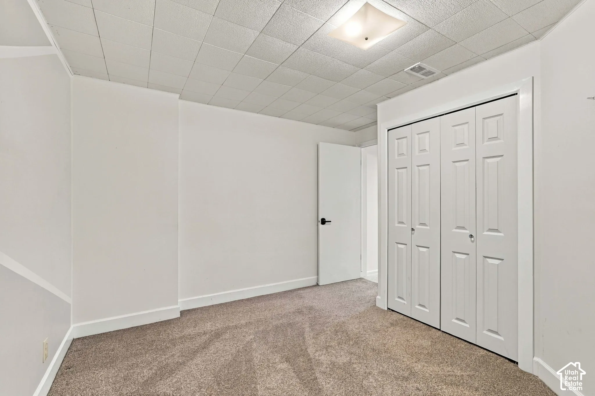 Wall-to-wall carpeting with white walls and trim
