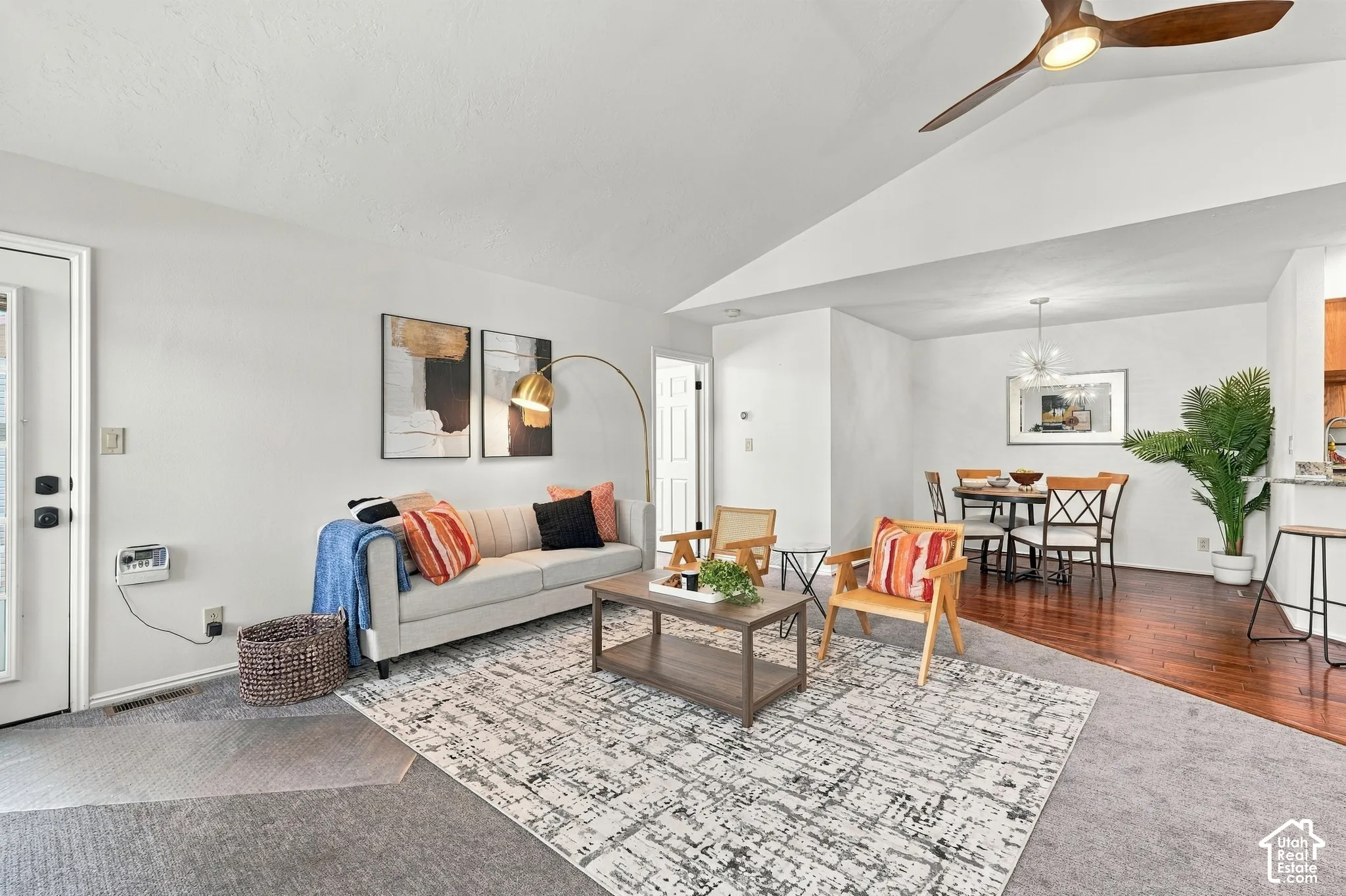 Vaulted ceilings with a ceiling fan, recessed lighting, and wood-finish flooring in the dining area