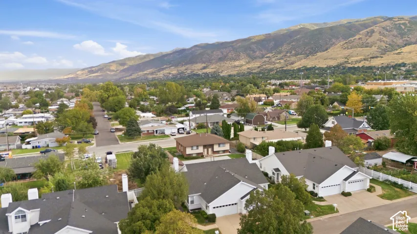 Established neighborhood setting with mature trees and mountain backdrop