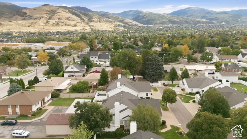 Residential area with mountain backdrop, established landscaping, and varied rooflines
