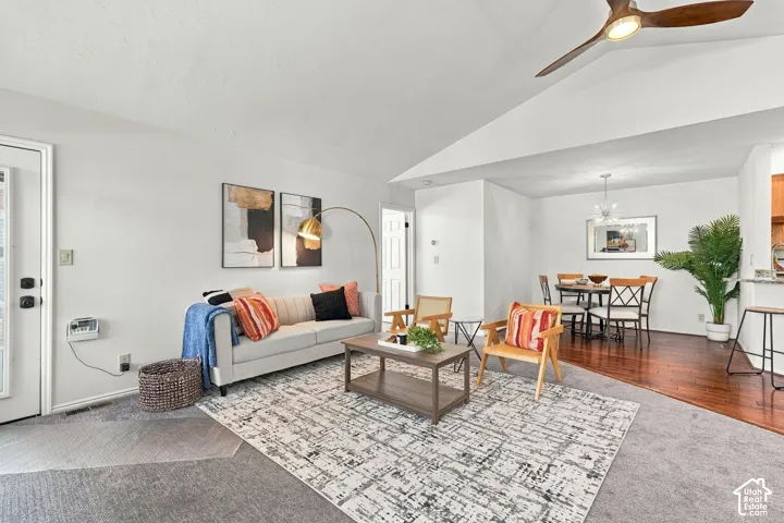 Vaulted ceilings with a ceiling fan, recessed lighting, and wood-finish flooring in the dining area