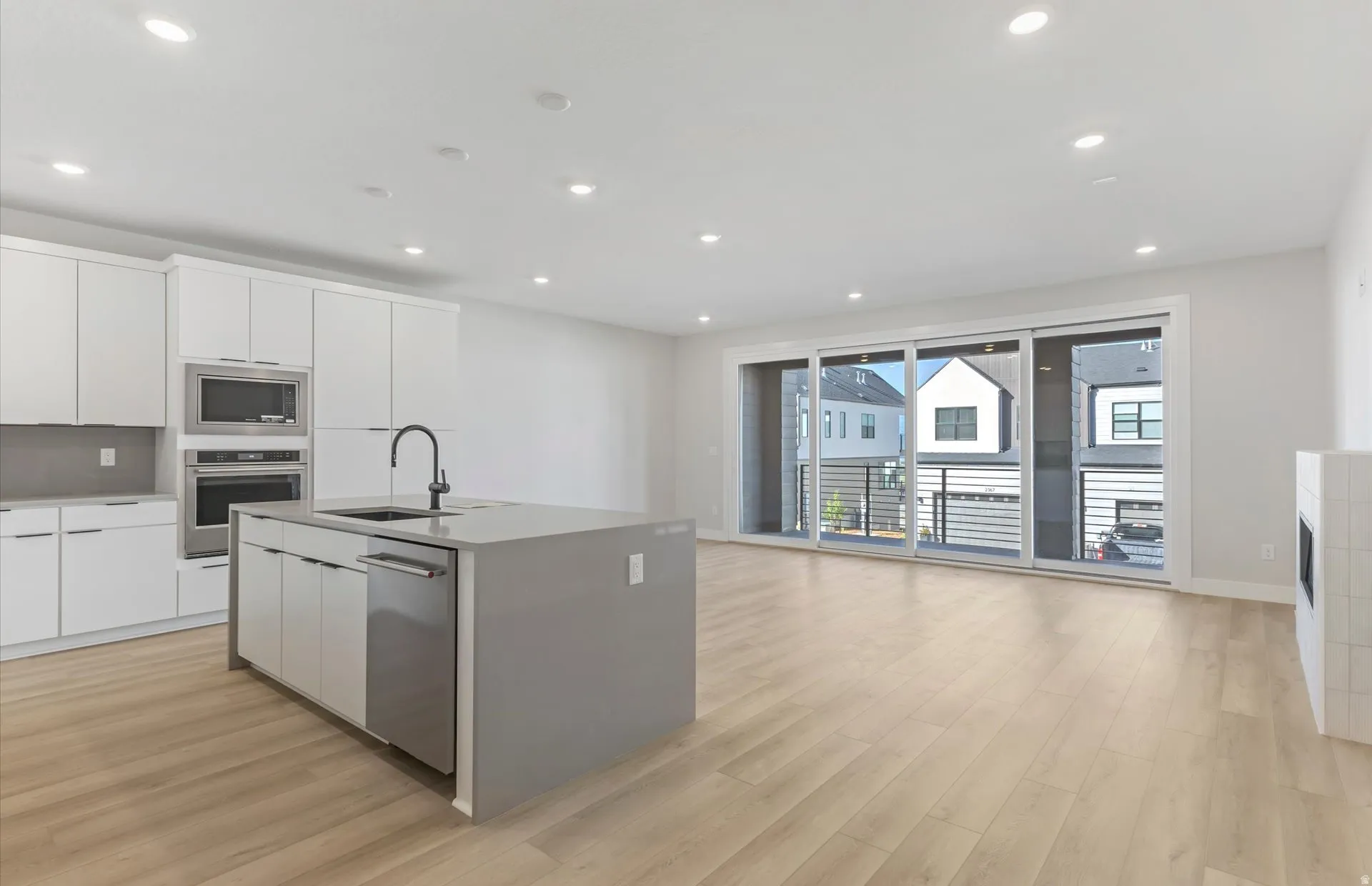 Open-concept living space with wood-finish flooring