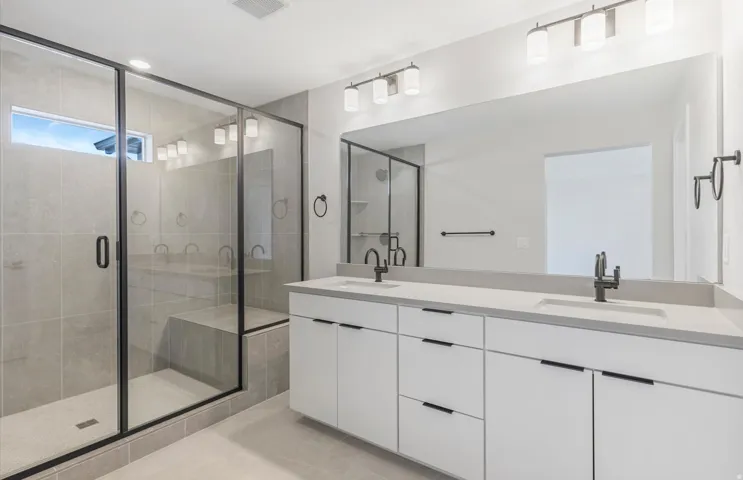 Expansive walk-in shower with glass enclosure and built-in bench