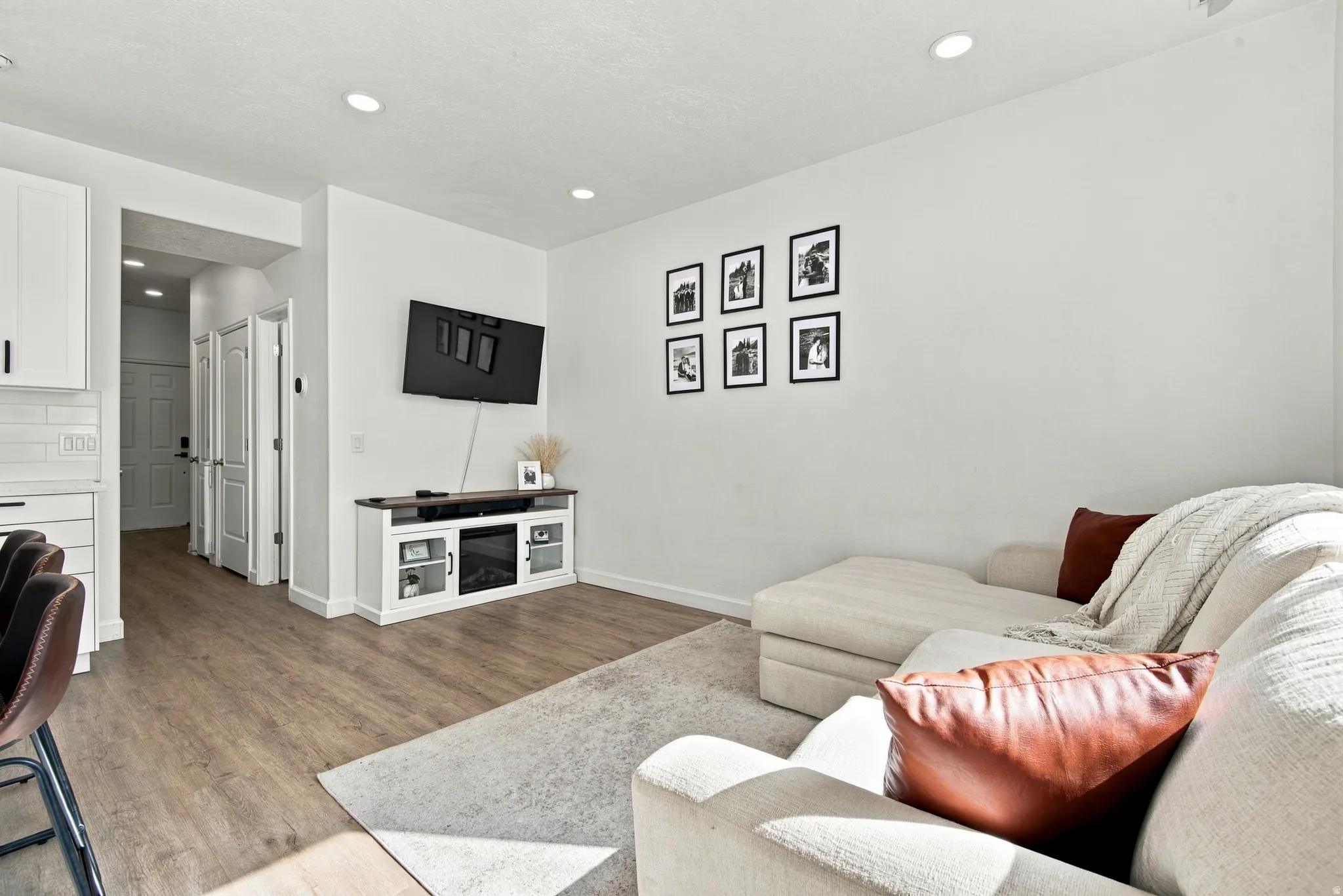 Recessed lighting, wood-finish flooring, and white interior doors
