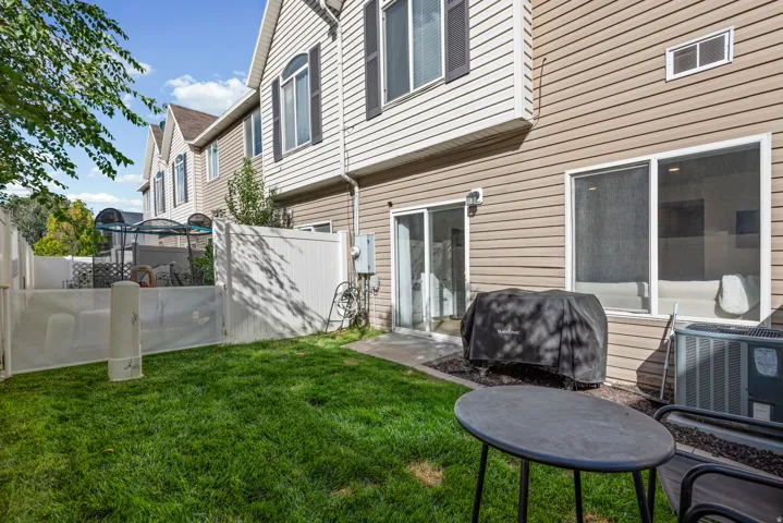 Private fenced backyard with a patio area and direct access to the interior via a sliding glass door