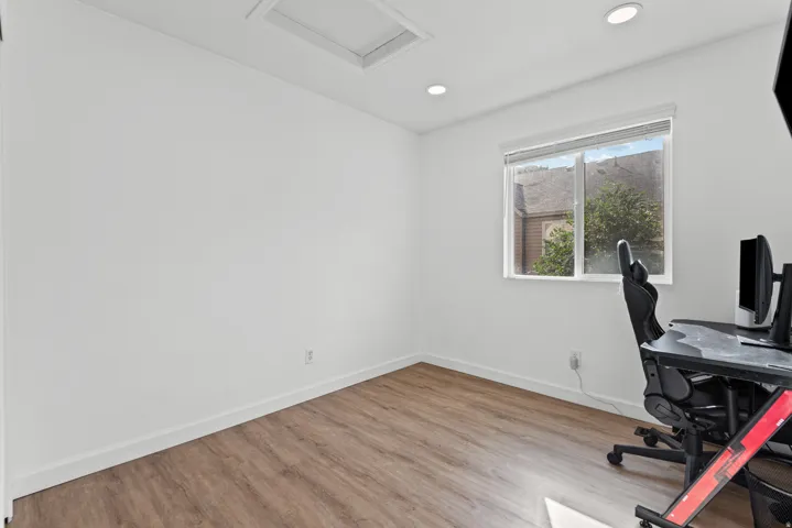 Wood-finish flooring with white baseboards