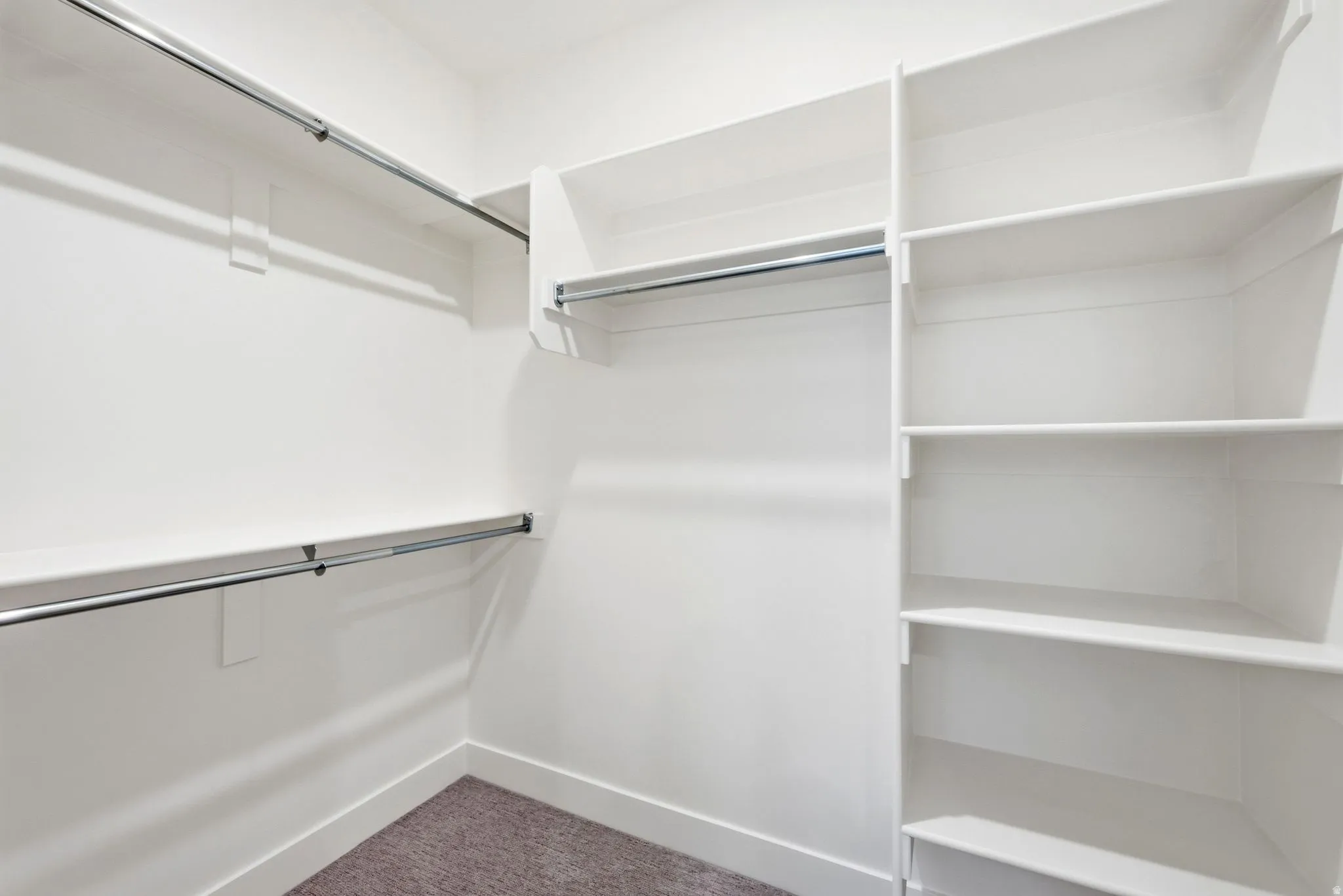 Custom closet system featuring multiple shelves and hanging rods