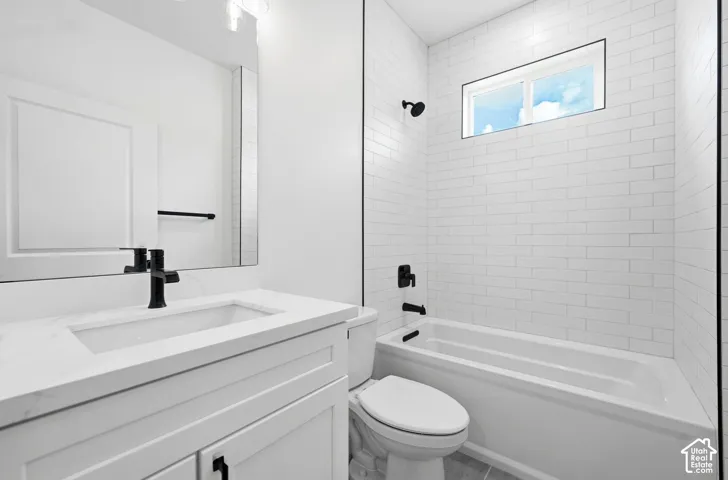 White subway tile shower surround with an integrated window, a white vanity with a rectangular undermount sink, and matte black fixtures