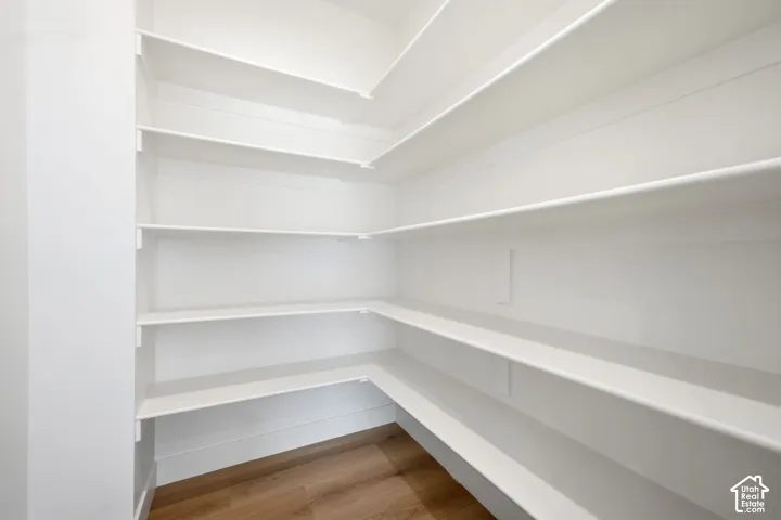 Built-in white shelving, wood-finish flooring